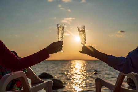 couple drinking champagne near seaの写真素材