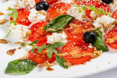 Caprese salad with mozzarella cheese, tomatoes and basilの写真素材