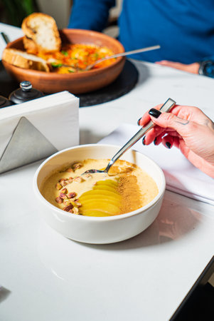 woman eating smoothie bowl in cafeの写真素材