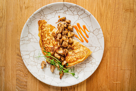 omelet with mushrooms on wooden backgroundの写真素材
