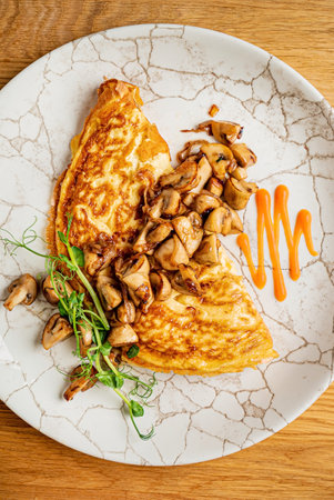 omelet with mushrooms on wooden backgroundの写真素材