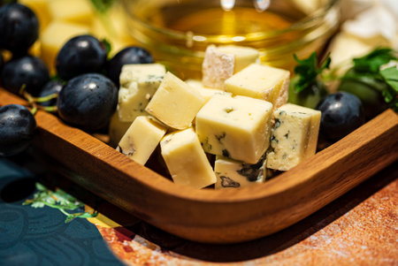 cheese, grapes and wine on tableの写真素材