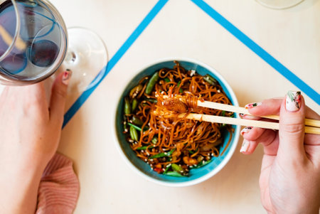 woman eating noodle in cafeの写真素材
