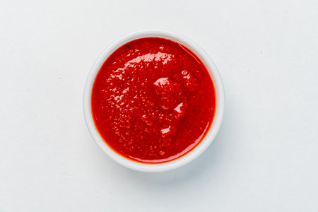 bowl of red tomato sauce ketchup Isolated on whiteの写真素材