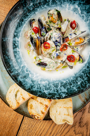 mussels with cream sauce with breadの写真素材