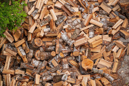 Pile of chopped firewood ready for winter. Firewood background.