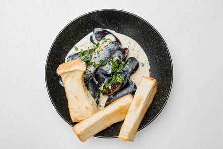 baked mussels with sauce and breadの写真素材