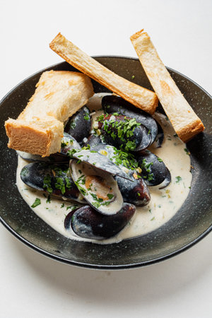 baked mussels with sauce and breadの写真素材
