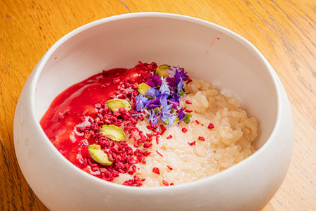porridge with strawberry sauce and seedsの写真素材
