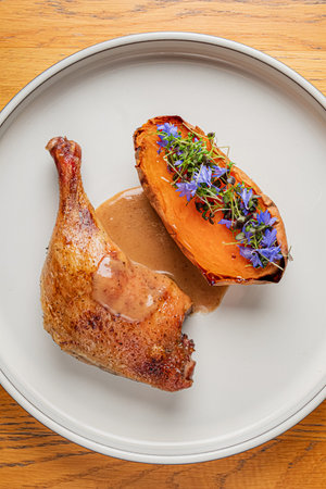 duck leg with sweet potatoの写真素材