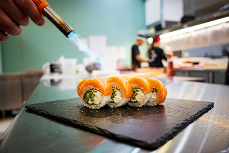 chef cooking sushi in restaurantの写真素材
