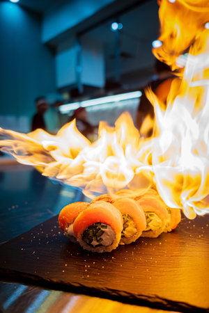 sushi with flame in restaurantの写真素材
