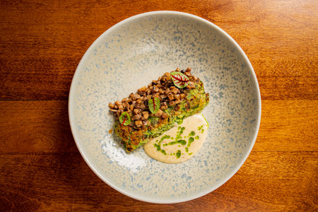 broccoli cake with sauce on plate