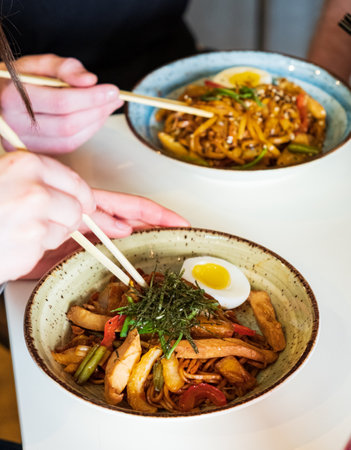 Savor vibrant Asian dishes made with fresh ingredients in a warm atmosphere.の写真素材