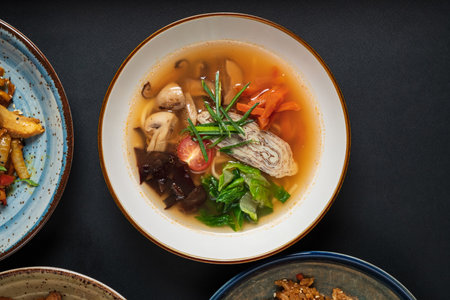 A hearty soup brimming with colorful vegetables and delicate flavors, perfect for a cozy meal.の写真素材