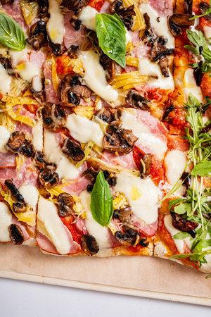 Savory pizza loaded with mushrooms, ham, and basil creates a delightful culinary experience.の写真素材