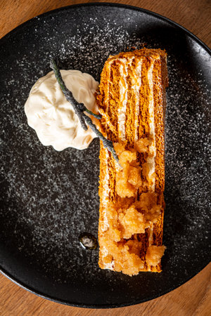 A layered cake with creamy ice cream and delightful textures entices the senses.