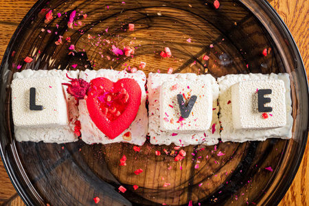 Colorful confectionery features letters and heart, crafted with care to celebrate affection and joy.の写真素材