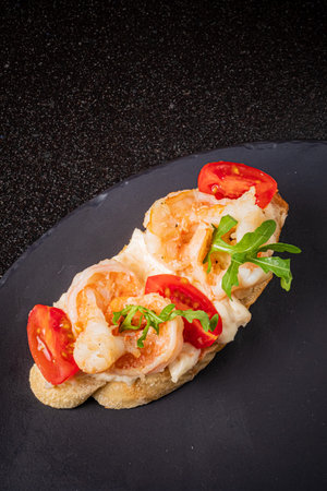 Succulent shrimp paired with juicy tomatoes and arugula creates a vibrant culinary delight.の写真素材