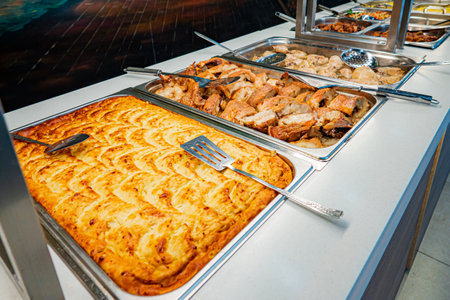 Array of mouthwatering dishes featuring baked goods and grilled meats at a lively culinary event.の写真素材