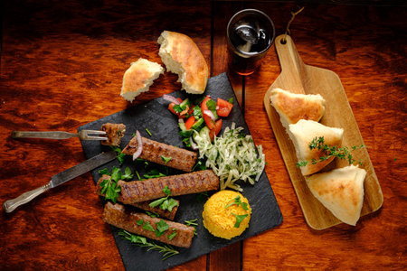 A vibrant mix of grilled meat, rice, and veggies invites warmth in a cozy setting.