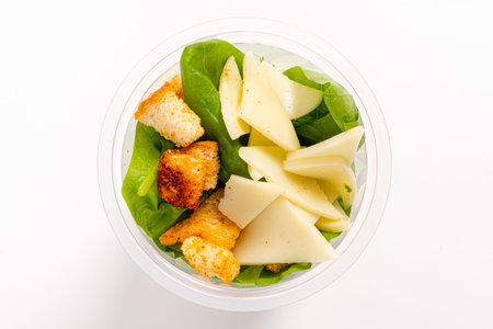 Fresh spinach combined with crunchy croutons and slices of cheese creates a nourishing delight.の写真素材