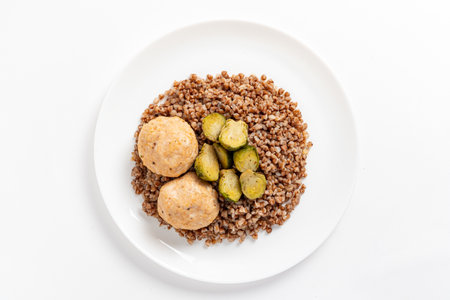 Buckwheat with meatballs and roasted Brussels sprouts makes a wholesome meal.の写真素材