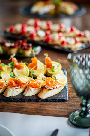 A variety of vibrant canapÃ©s with fresh garnishes invites guests to enjoy fine dining.の写真素材