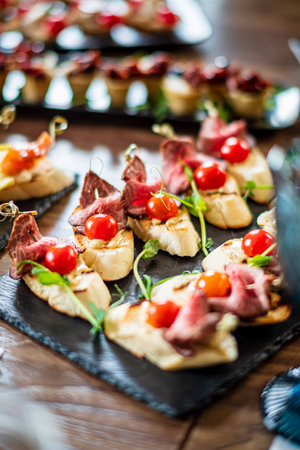 Elegant appetizers with fresh tomatoes and tender meat invite all to enjoy.