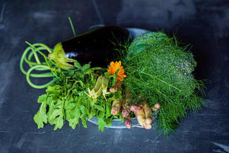 A selection of fresh vegetables on a rustic plate, showcasing seasonal produce.の写真素材