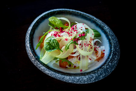Vibrant ribbons of fennel mingle with fresh herbs, creating a delightful and colorful dish.の写真素材