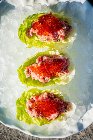 Enjoy a delightful Christmas appetizer featuring fresh seafood on a bed of ice for a festive touch.の写真素材