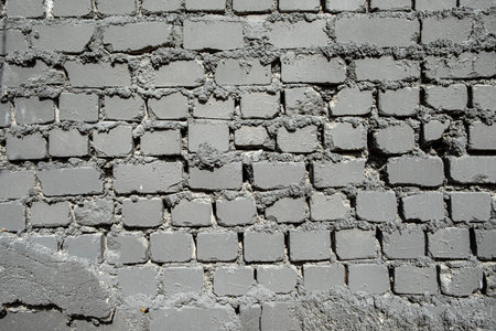 Weathered gray bricks create a captivating texture that adds character to any urban environment.の写真素材