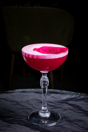 A stunning pink cocktail topped with dragon fruit, showcasing creativity and elegance.の写真素材