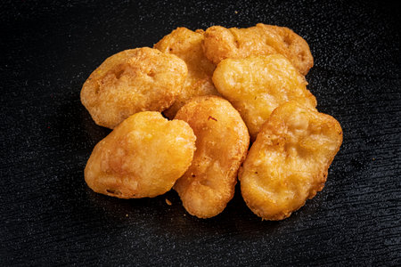 Deliciously crispy nuggets sit in a tempting pile, ready to be enjoyed during snack time or meals.の写真素材