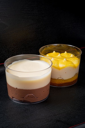 Two exquisite desserts showcase rich chocolate and creamy mango layersâideal for cravings!の写真素材