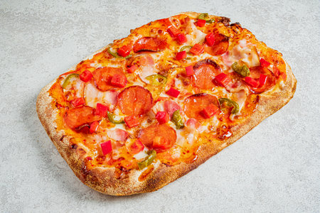 Colorful pepperoni pizza with fresh toppings sits appetizingly on a light surface, inviting all.の写真素材