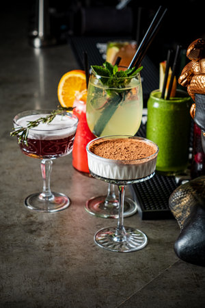 Tasty drinks and desserts on a colorful bar counter, capturing the festive vibe.の写真素材