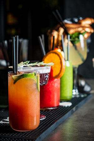 Colorful cocktails with fresh garnishes invite patrons to enjoy a lively night out at the bar.