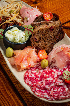 A curated selection of cured meats, cheeses, olives, and bread offers a delightful experience.