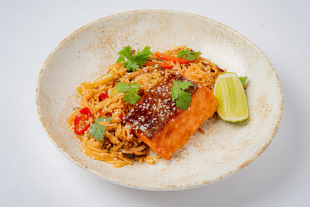 Enjoy vibrant salmon on seasoned rice, topped with herbs and lime.
