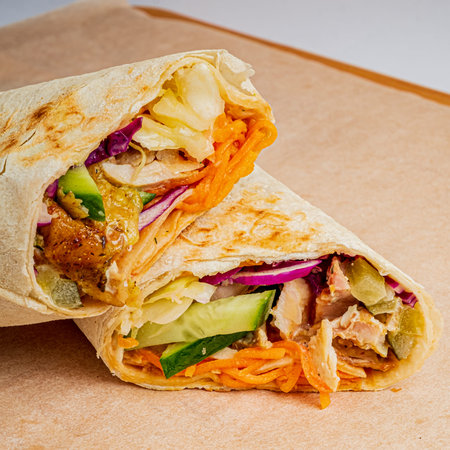 A vibrant wrap showcases a blend of crisp vegetables and tender chicken, perfect for a quick meal.