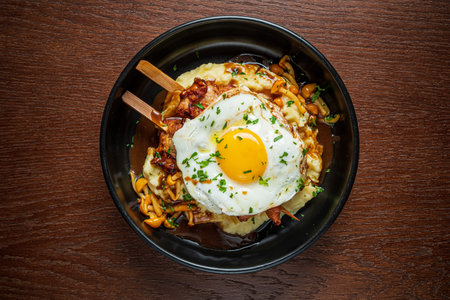 A delicious breakfast of creamy mashed potatoes topped with tasty ingredients and egg.
