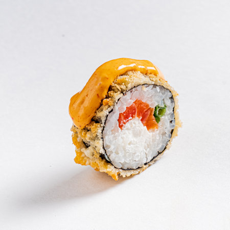 A sushi roll with a crunchy exterior, fresh seafood, and vibrant colors entices the senses.の写真素材