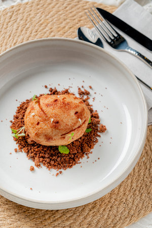 Savory dish beautifully plated with fine crumbs and fresh herbs, showcasing culinary artistry.