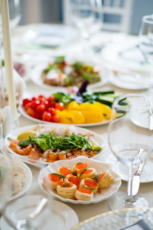 Delicious plates filled with vibrant fruits, vegetables, and seafood enhance a joyful celebration.の写真素材