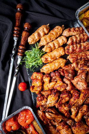 A colorful spread of grilled meats and veggies tempts the appetite with barbecue delights.の写真素材