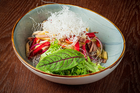 Enjoy a vibrant salad of fresh veggies and sliced meats in a stylish bowlâideal for lunch!の写真素材