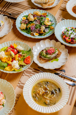 A vibrant assortment of salads, soups, and toppings displayed beautifully on elegant plates.