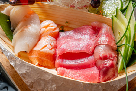 Colorful selection of sushi showcases fresh fish and garnishes on a wooden boat presentation.の写真素材